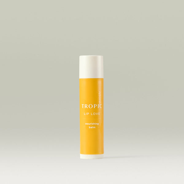 Tropic Lip Love nourishing balm in a yellow tube, designed to hydrate and protect lips.