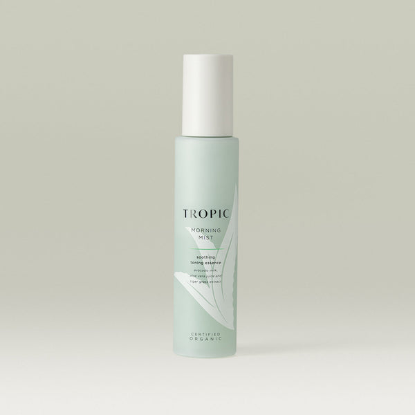 Tropic Morning Mist soothing toning essence. Contains avocado milk, aloe vera juice and tiger grass extract. Certified Organic.
Glass light green bottle with white lid.  Aloe vera plant design features behind black text.