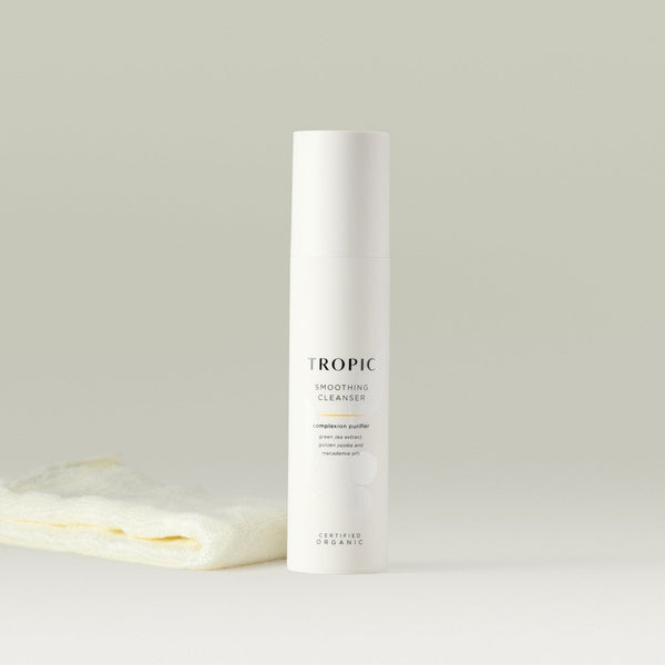 Tropic Smoothing Cleanser complexion purifier 120ml with bamboo face cloth.
Contains green tea extract, golden jojoba and macadamia oils. Certified Organic. White tube with white lid. Leaf design features behind black text. 